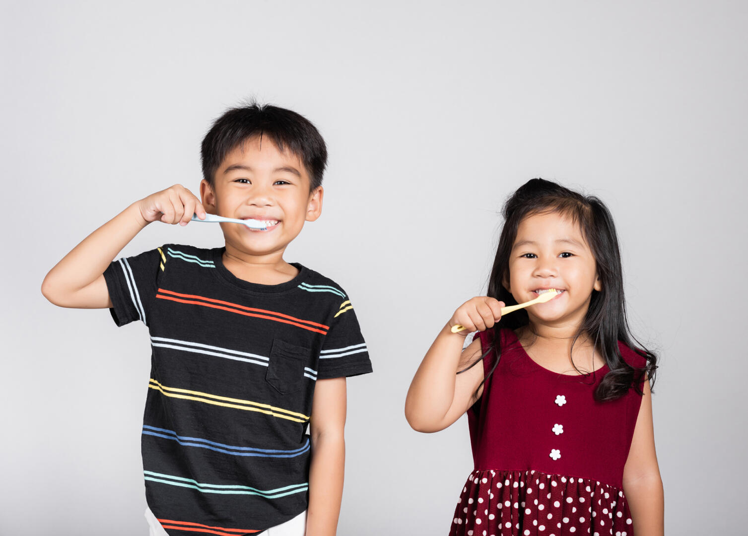 Little cute kid boy and girl 3 6 years old brushing teeth and smile in studio shot isolated